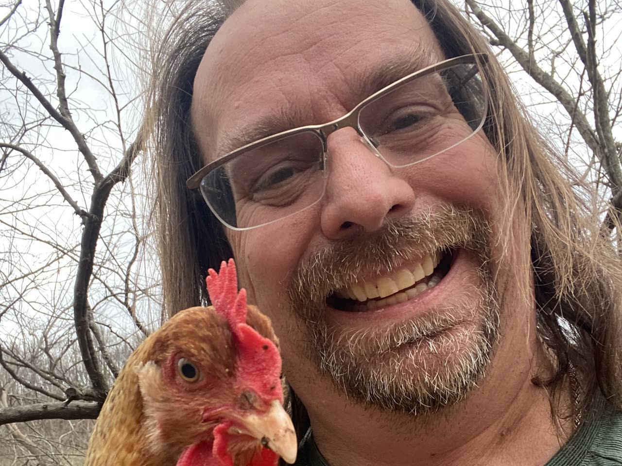 Kevin, founder of bwak.news, holding one of his chickens